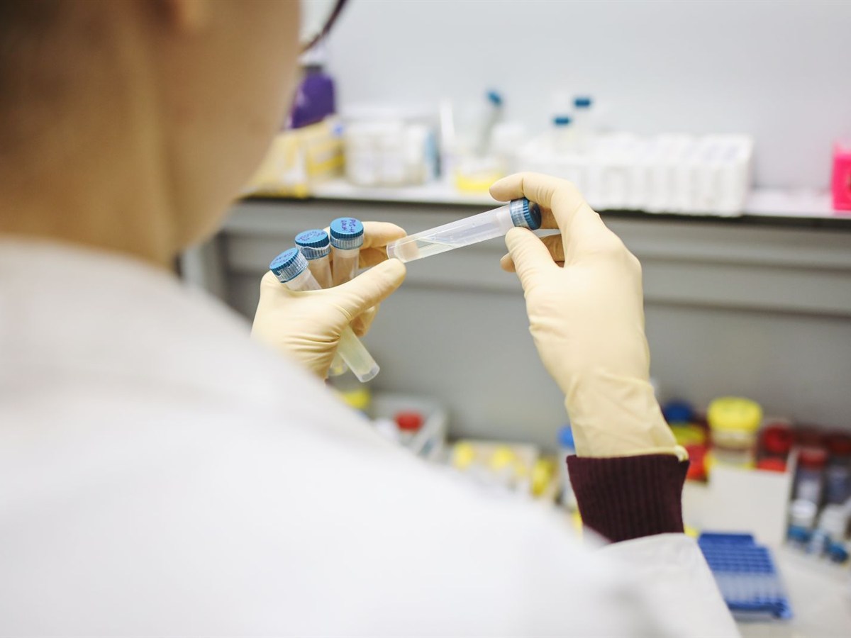 Scientist holding test tubes in the quality control lab